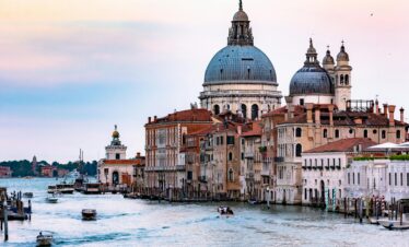 Captivating view of the Grand Canal in Venice with the iconic Santa Maria della Salute basilica and bustling waterways.