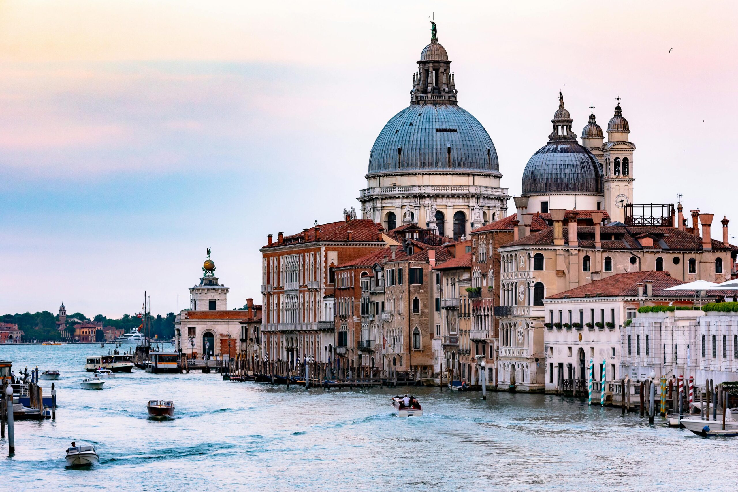 Captivating view of the Grand Canal in Venice with the iconic Santa Maria della Salute basilica and bustling waterways.